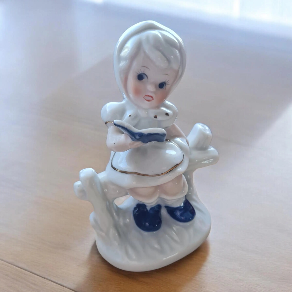 Vintage porcelain figurine of a little boy and a little girl.