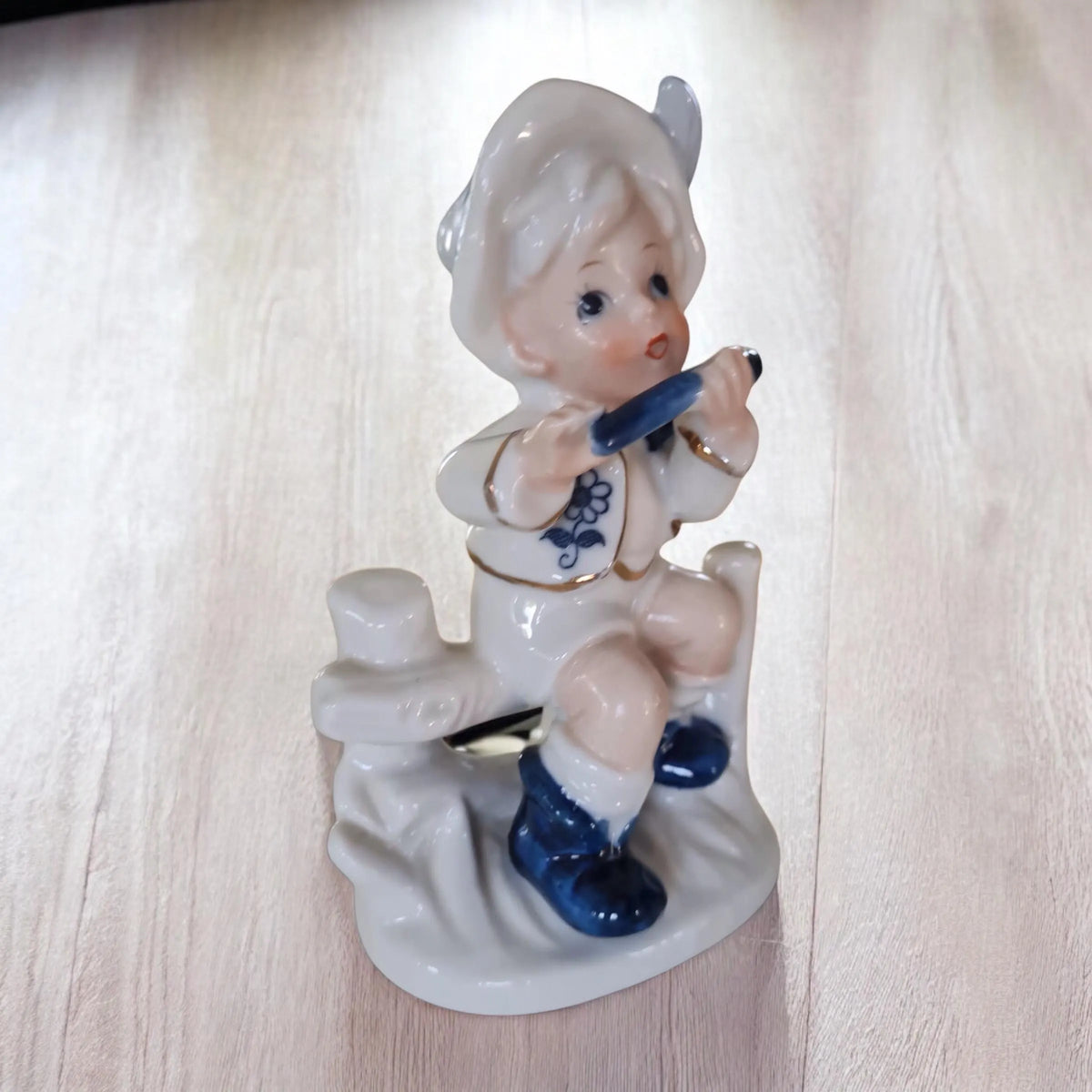 Vintage porcelain figurine of a little boy and a little girl.