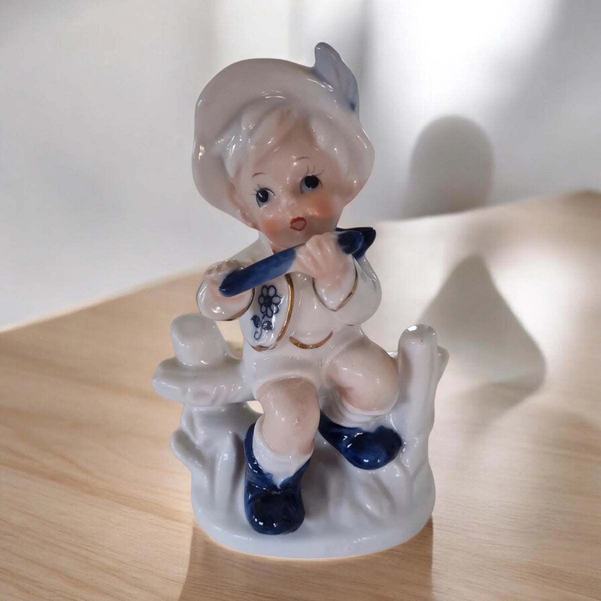 Vintage porcelain figurine of a little boy and a little girl.