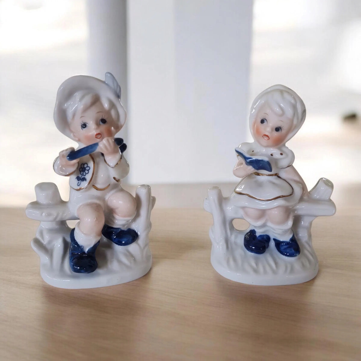 Vintage porcelain figurine of a little boy and a little girl.